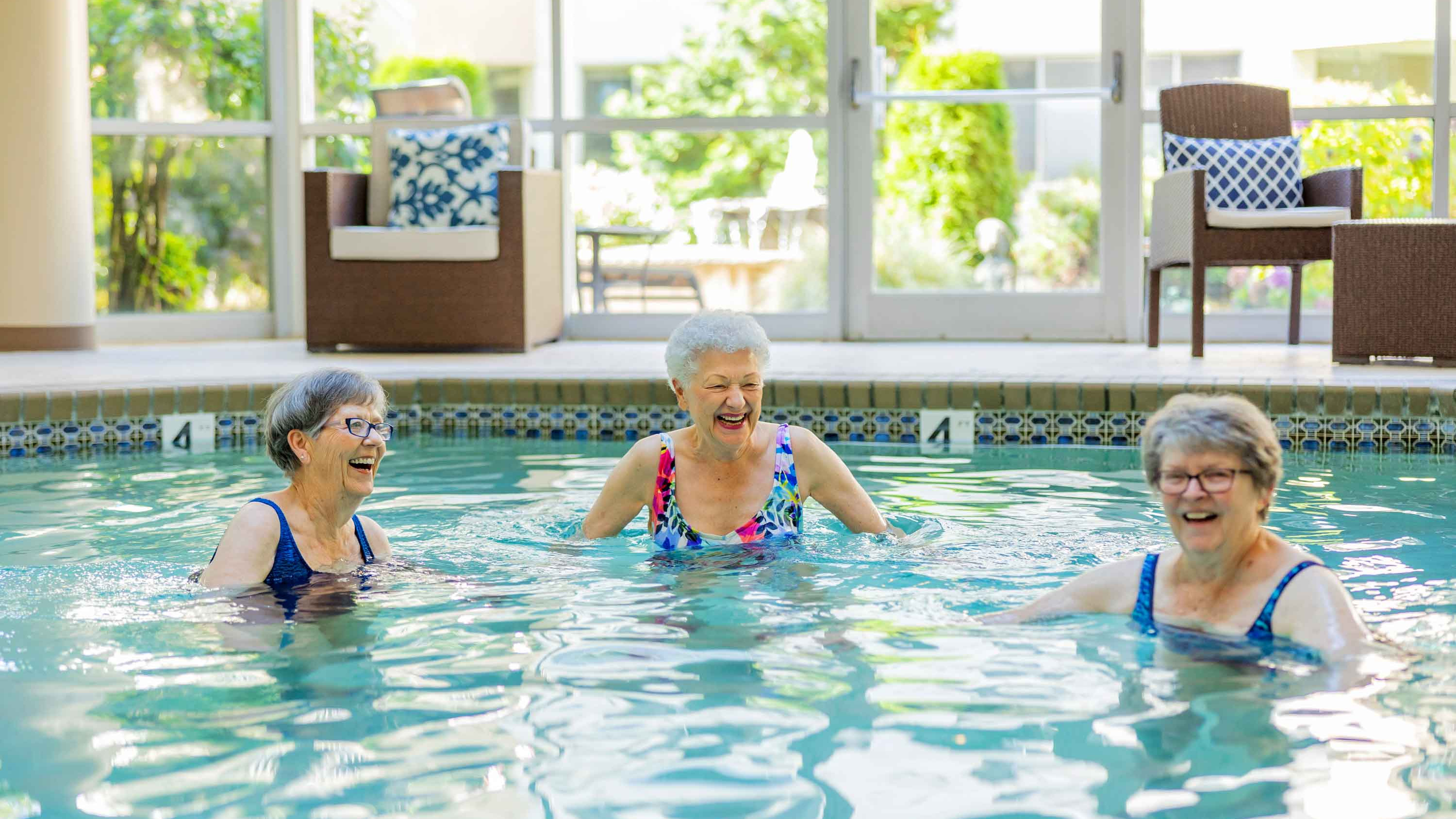 Three women in the spas pool enjoy a workout break at Cristwood Independent Living