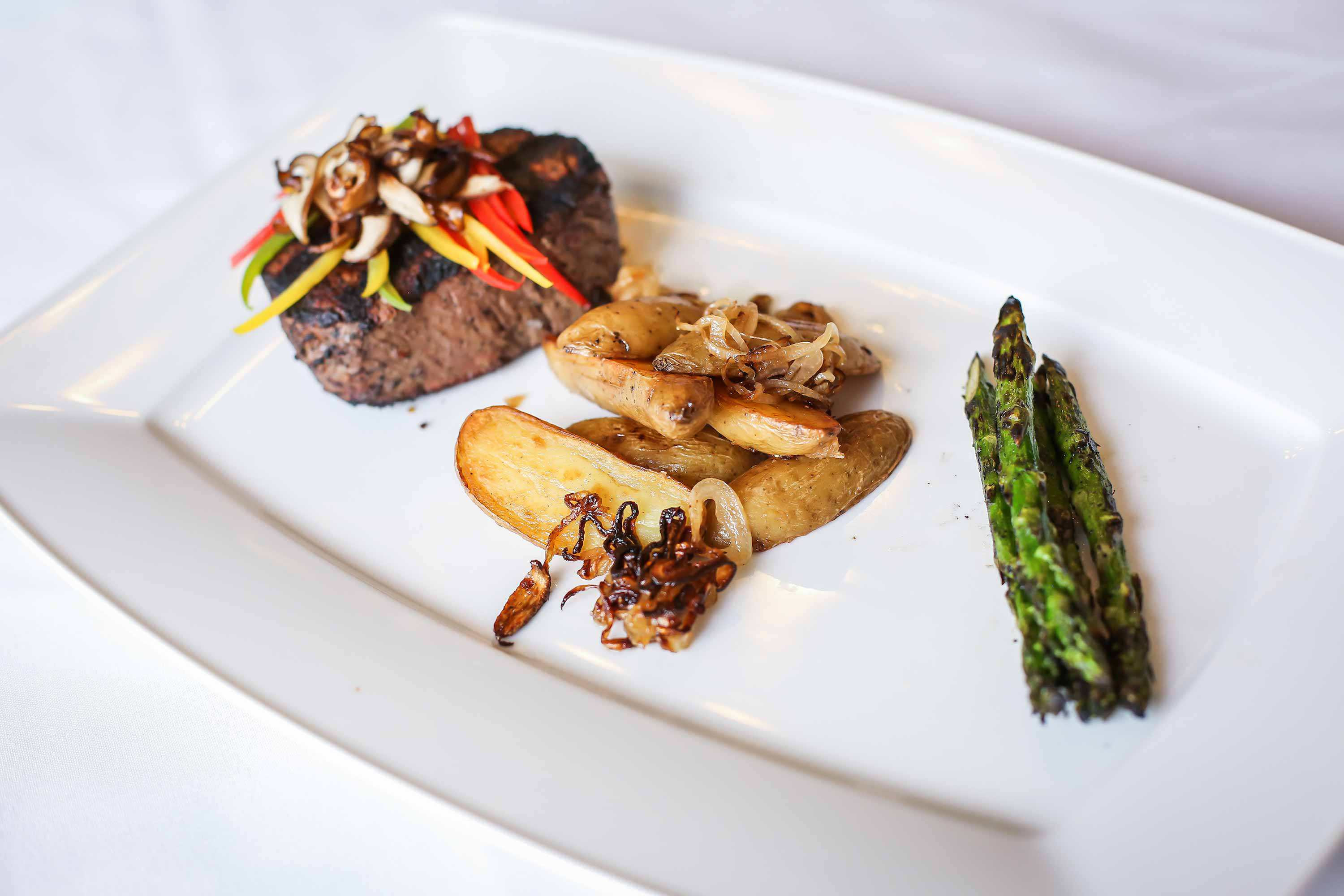 Steak, potato wedges, and asparagus