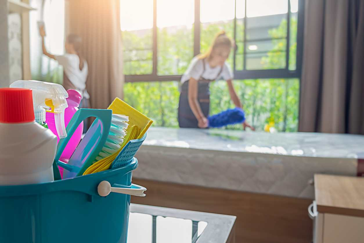 Housekeepers cleaning apartment