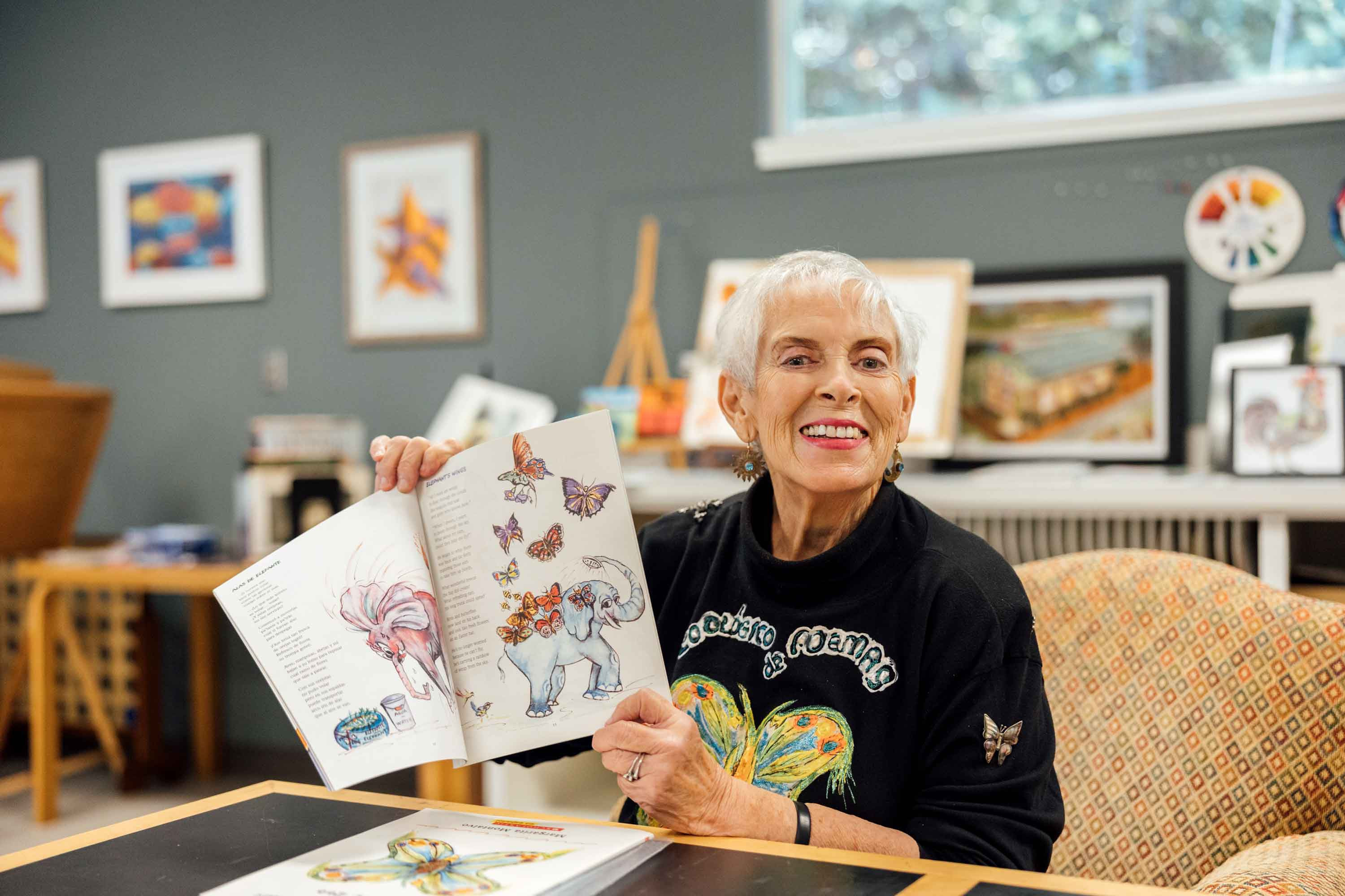 Resident displays her artwork in the Art Room at Cristwood Park