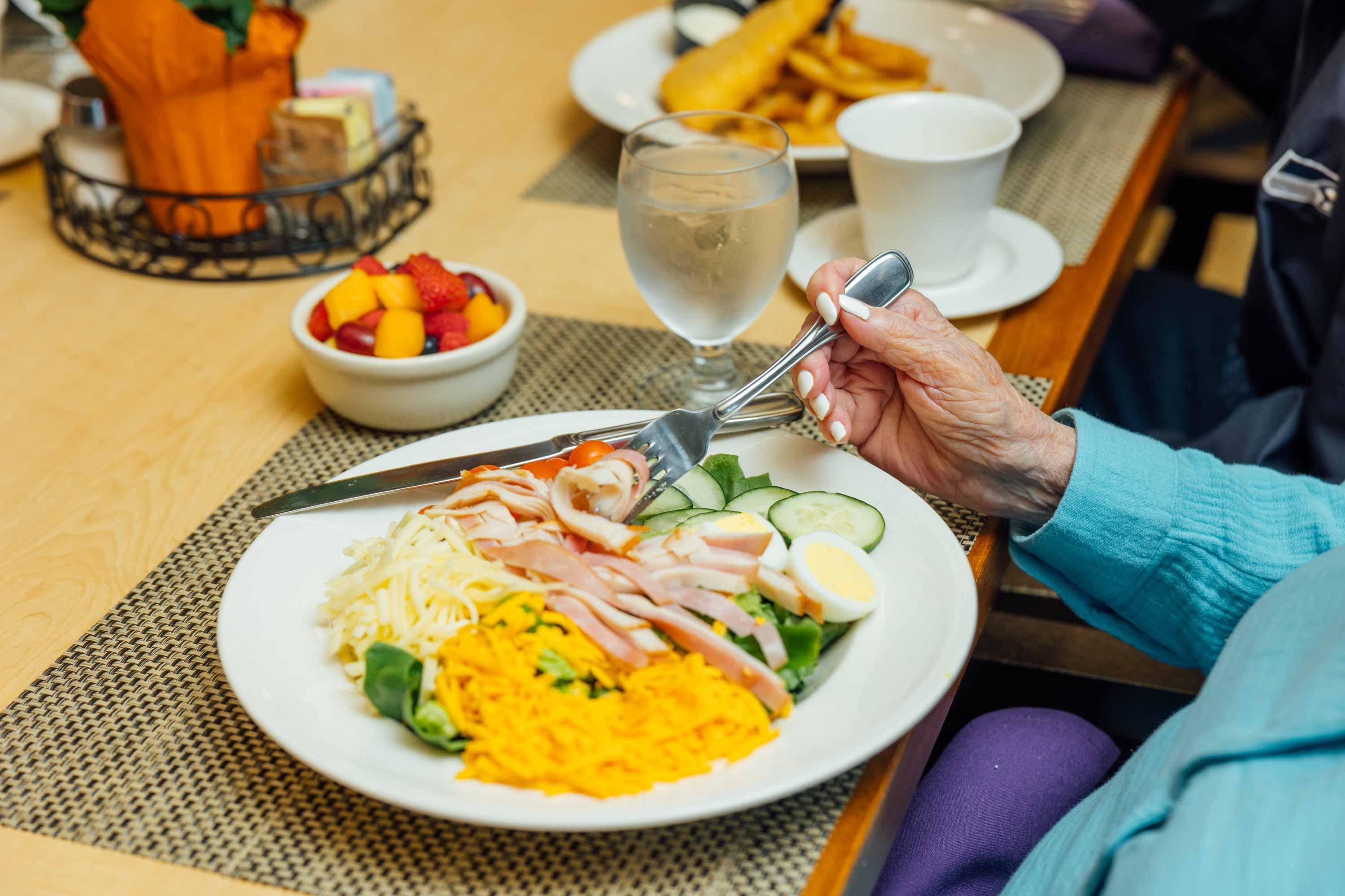 Resident enjoying a chef salad