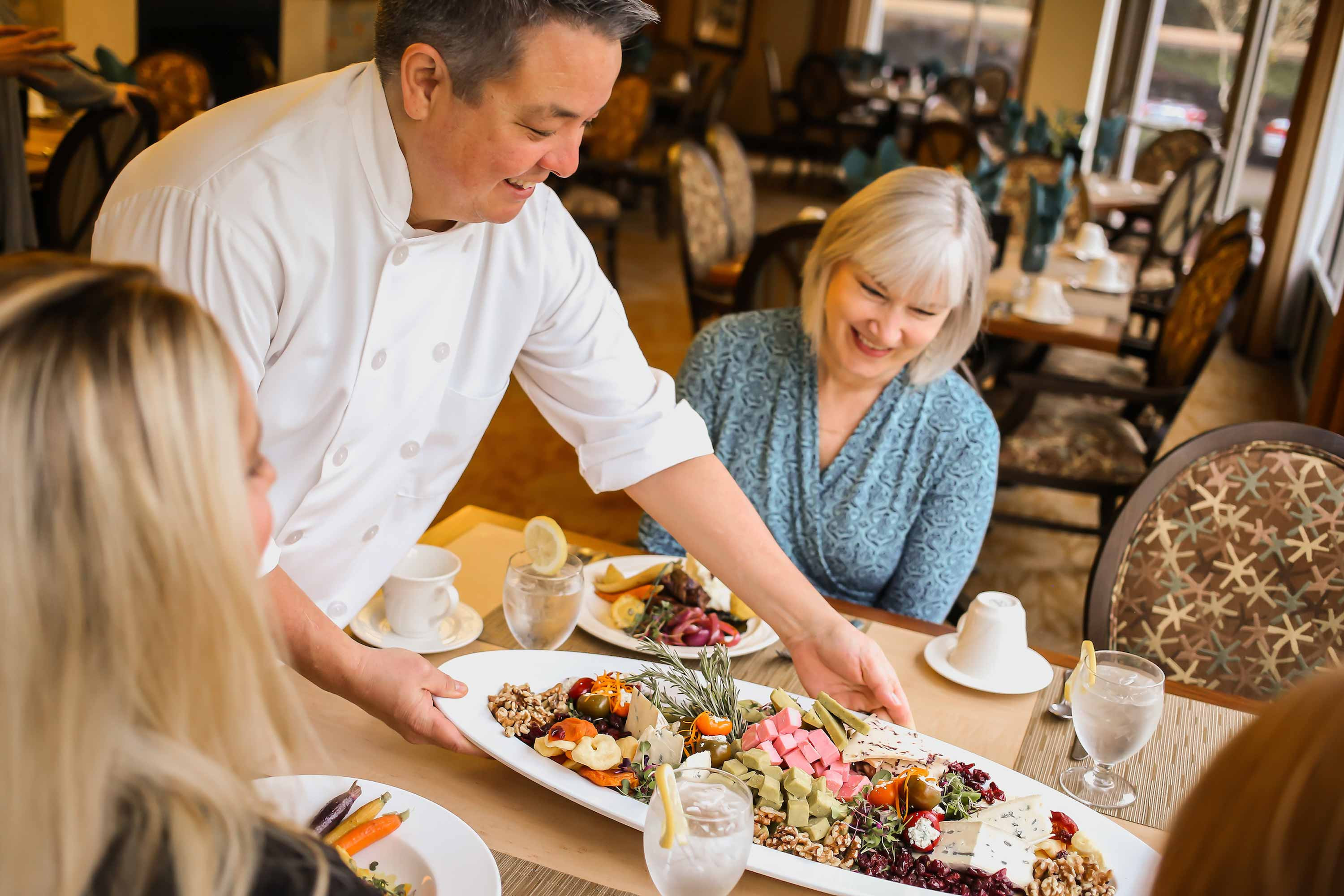 Cristwood's chef lays out platter of food for diners