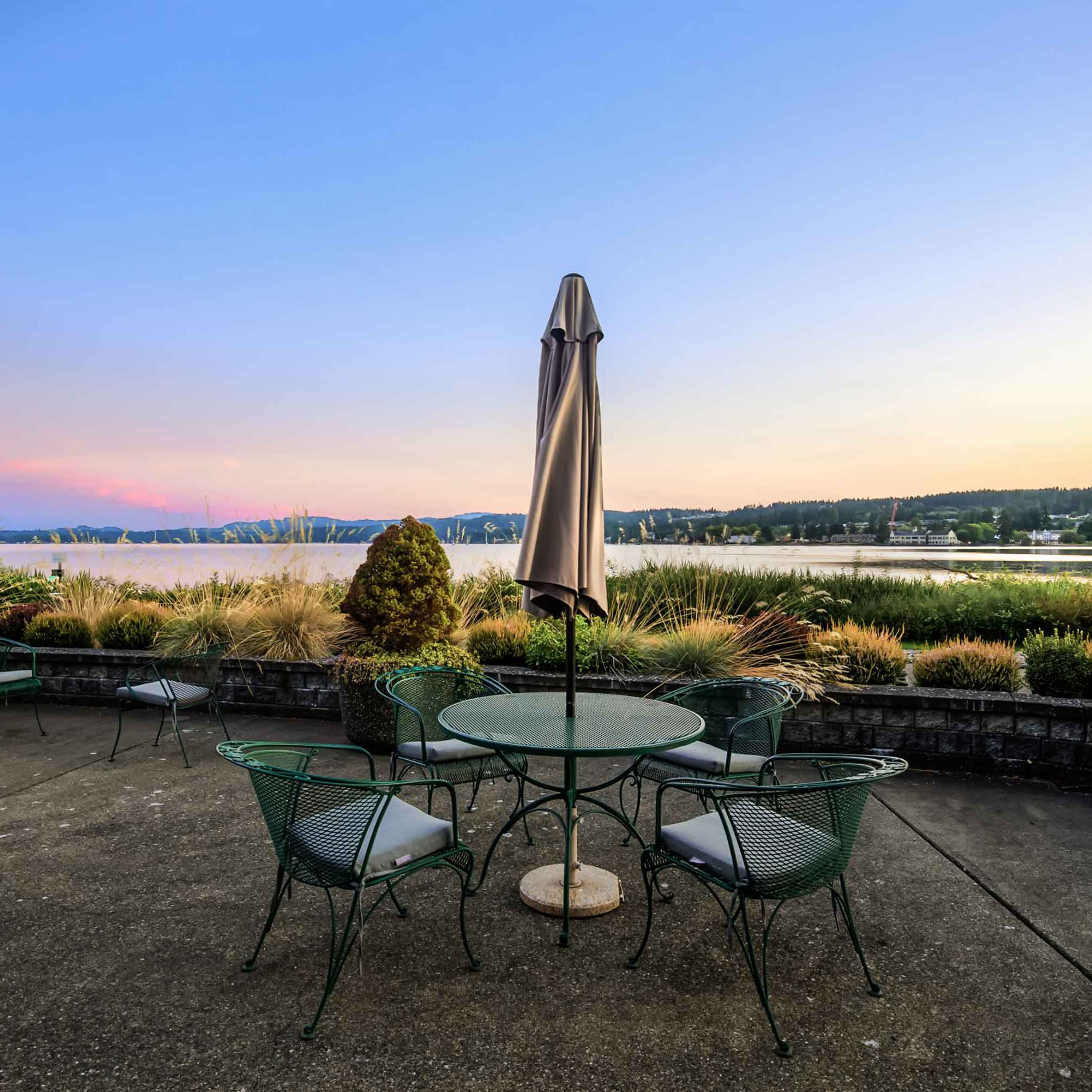 Umbrellaed table on Crista Shores patio, view of Dyes Inlet