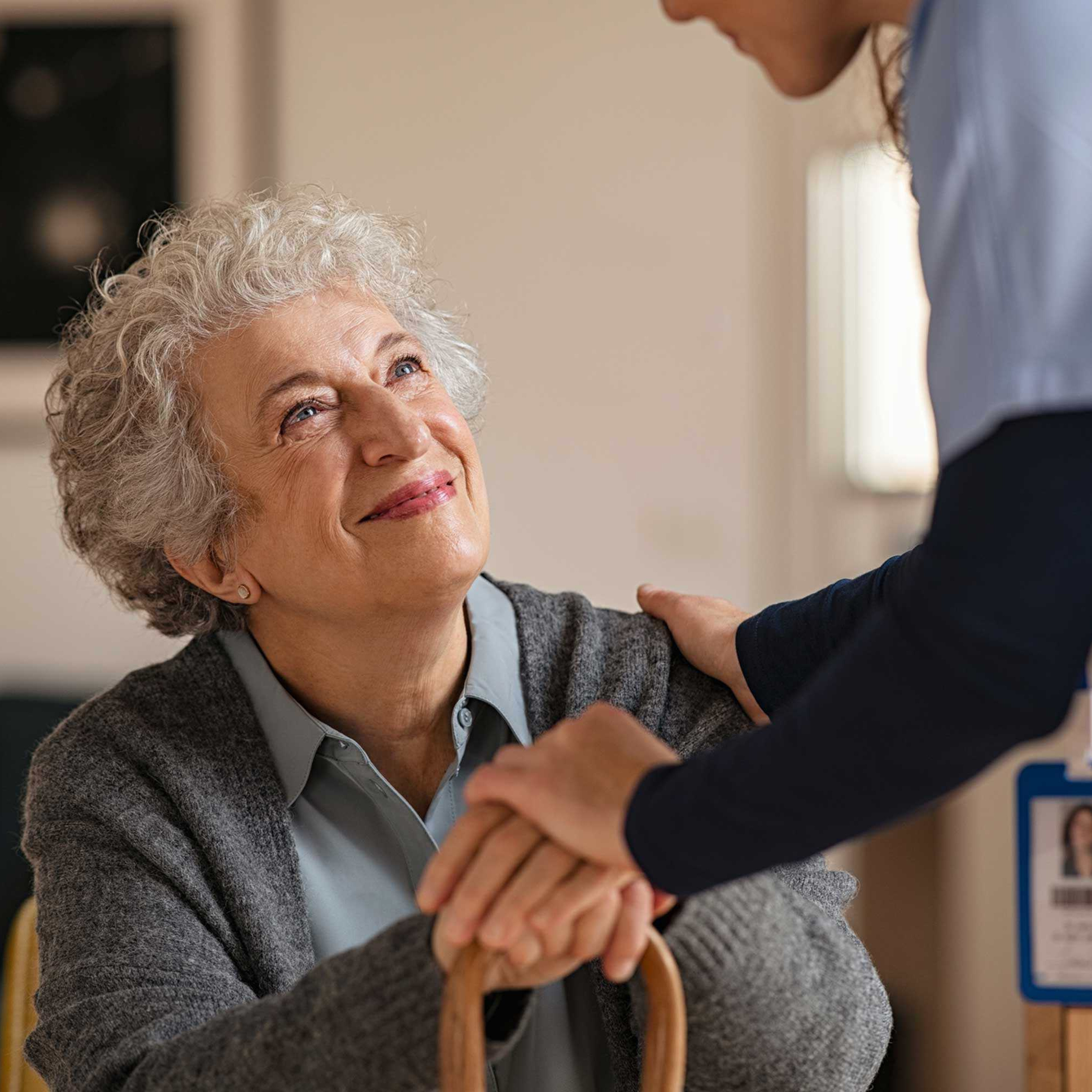 CRISTA Senior Living - Nurse greets seated resident